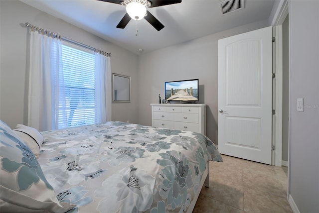 tiled bedroom featuring ceiling fan