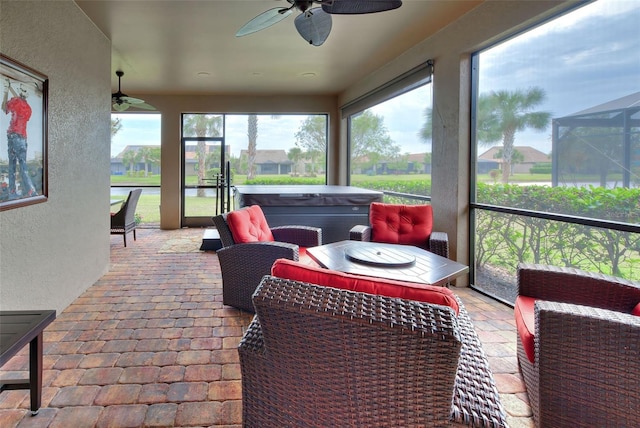 sunroom / solarium with ceiling fan and a jacuzzi