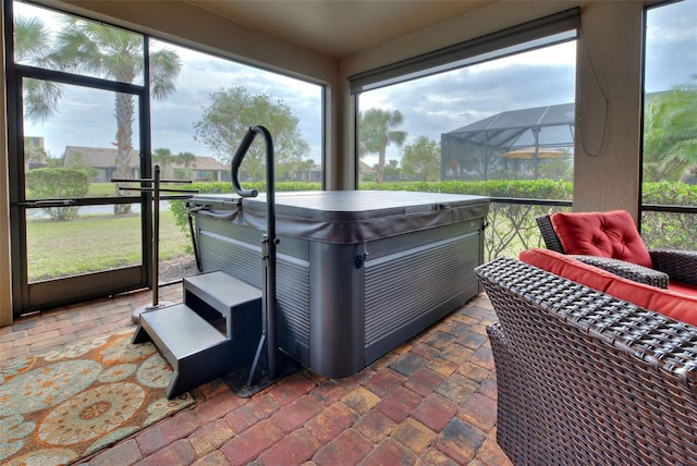 sunroom with a hot tub