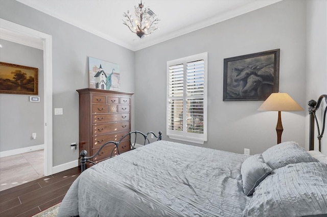 bedroom with crown molding and an inviting chandelier