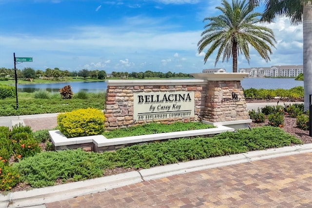 community / neighborhood sign featuring a water view