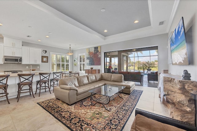 living room with light tile patterned flooring, visible vents, ornamental molding, and recessed lighting
