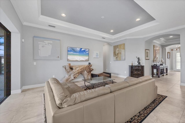 living room with arched walkways, recessed lighting, a raised ceiling, and crown molding