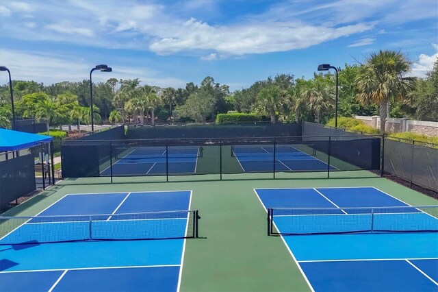 view of sport court featuring fence