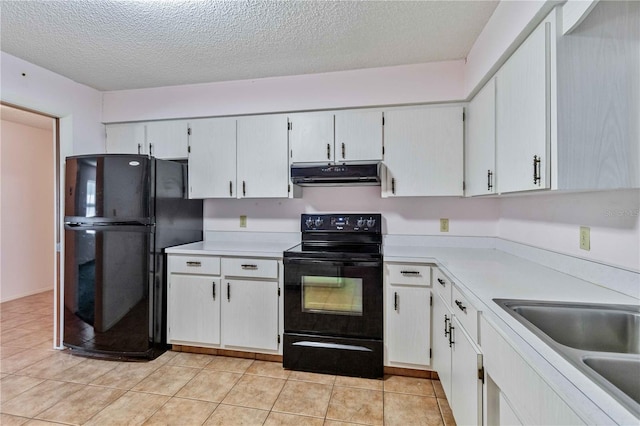 kitchen featuring light tile patterned flooring, a textured ceiling, white cabinetry, and black appliances