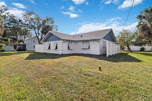 rear view of property featuring a yard