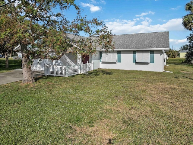 ranch-style house with a front lawn