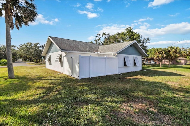 rear view of property featuring a lawn