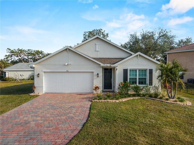 single story home featuring a garage and a front lawn