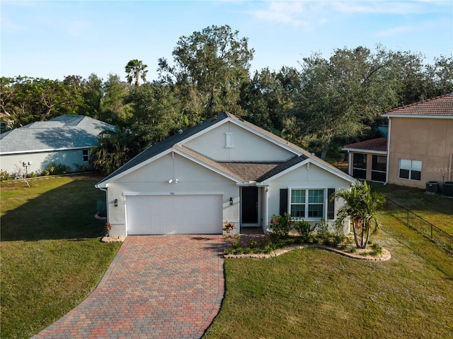 single story home with a garage and a front lawn