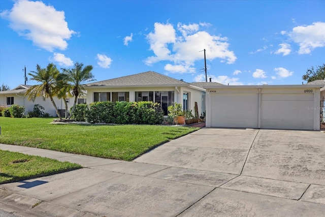 ranch-style home featuring a garage and a front yard