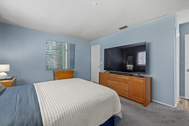 carpeted bedroom featuring a textured ceiling