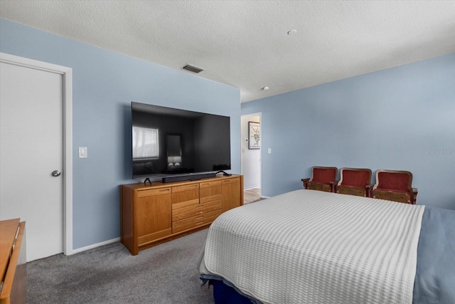 carpeted bedroom featuring a textured ceiling