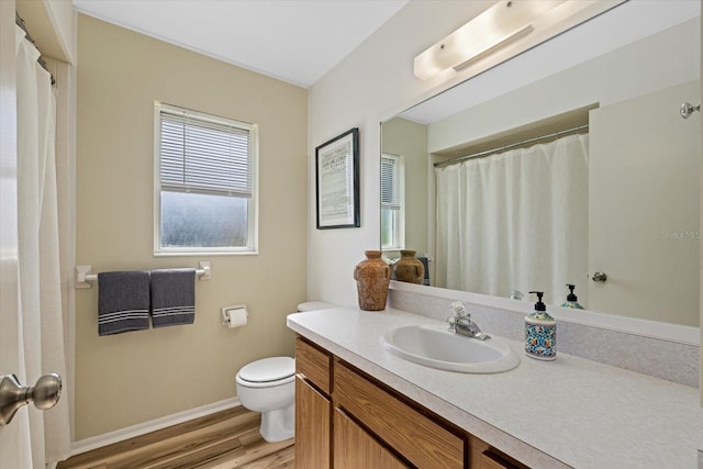 bathroom with hardwood / wood-style flooring, vanity, and toilet