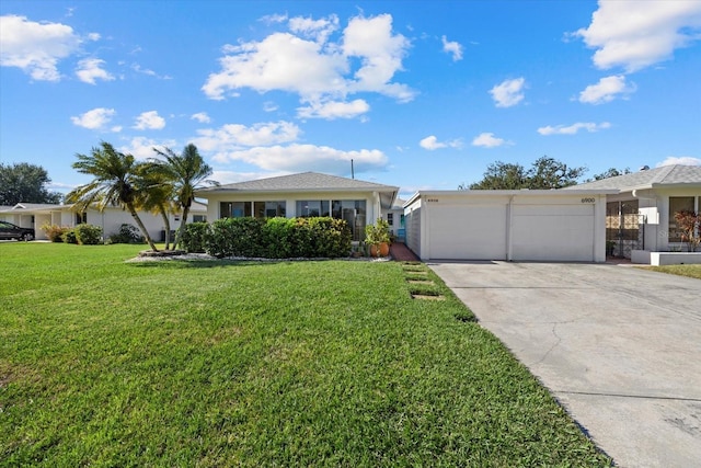 single story home with a garage and a front lawn