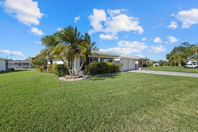 view of front of house featuring a front lawn and a garage