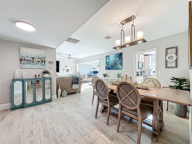 dining room with light wood-type flooring and ceiling fan