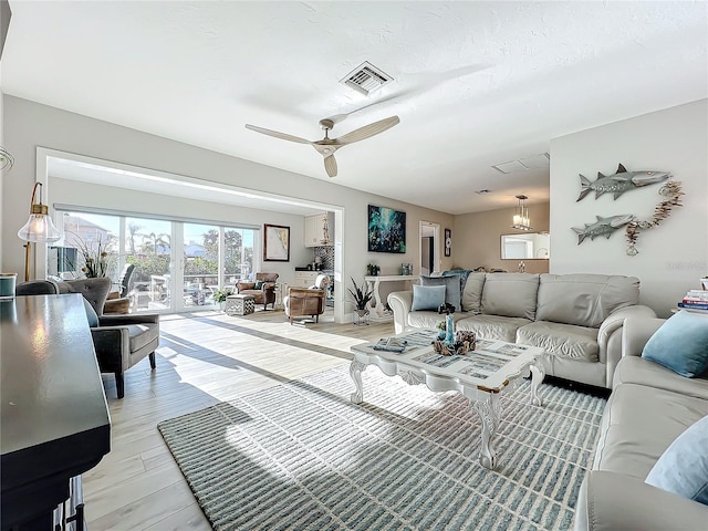 living room with light wood-type flooring and ceiling fan