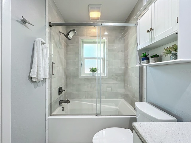 full bathroom featuring vanity, toilet, and enclosed tub / shower combo