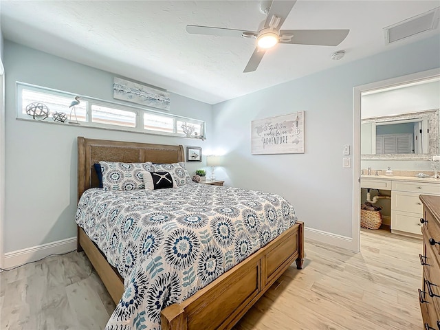 bedroom featuring ensuite bath, ceiling fan, and light hardwood / wood-style floors