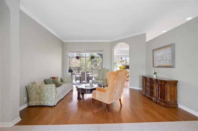 living room featuring wood-type flooring and crown molding