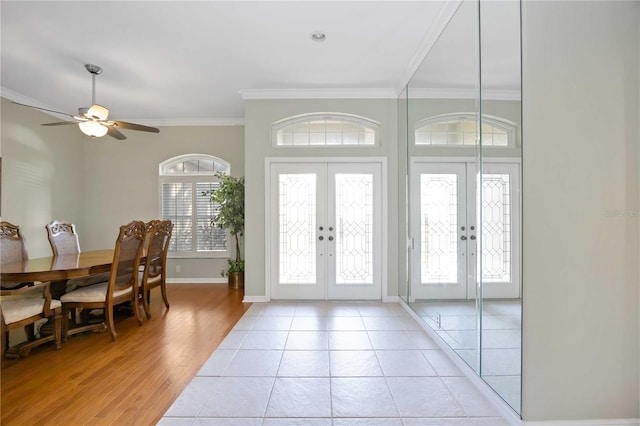 tiled entryway featuring ornamental molding, french doors, and ceiling fan