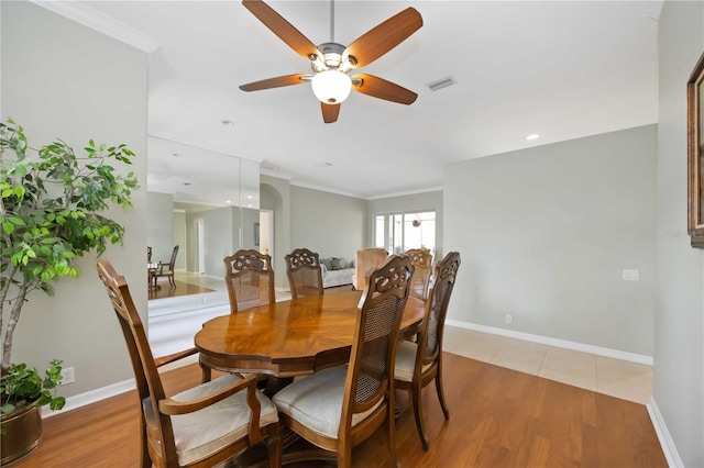 dining space featuring hardwood / wood-style flooring, crown molding, and ceiling fan