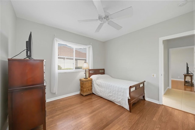 bedroom with hardwood / wood-style flooring and ceiling fan