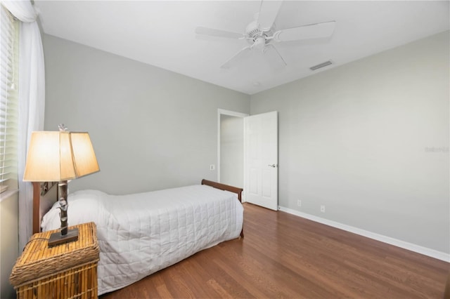 bedroom with dark wood-type flooring and ceiling fan