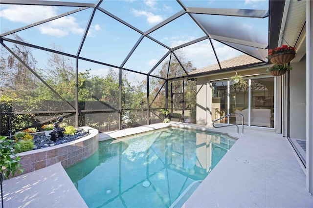 view of swimming pool with a lanai and a patio area