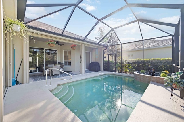 view of pool with a patio, a lanai, and ceiling fan