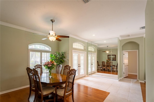 dining area with light tile patterned flooring, baseboards, ornamental molding, and french doors