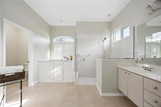 bathroom with a walk in shower, tile patterned flooring, vanity, and a bathing tub