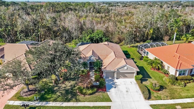 birds eye view of property with a view of trees