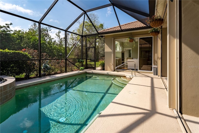 pool featuring a patio and glass enclosure