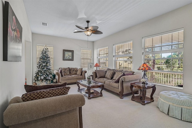 living room featuring carpet floors, plenty of natural light, and ceiling fan