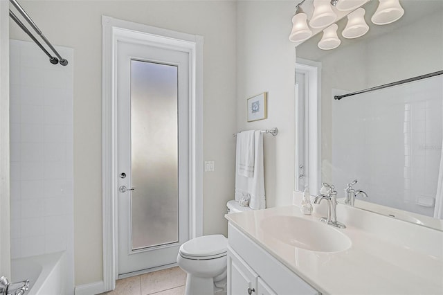 full bathroom featuring tile patterned flooring, vanity, toilet, and tiled shower / bath combo