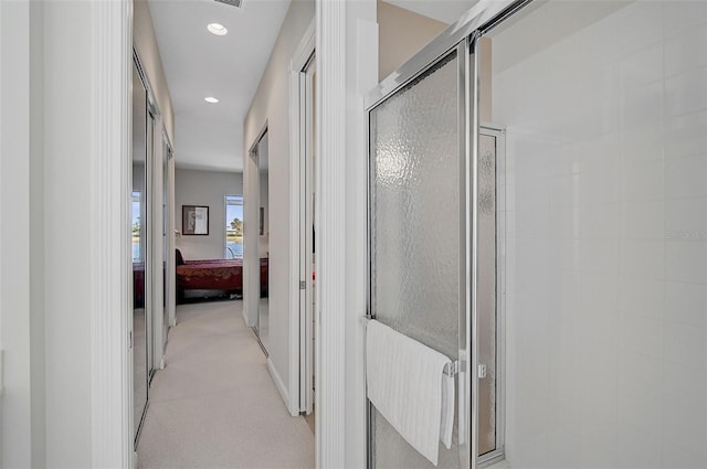 corridor with light colored carpet