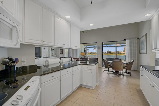 kitchen with white cabinets, pendant lighting, white appliances, and kitchen peninsula