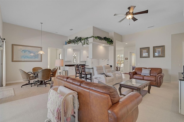 living room featuring ceiling fan and light carpet