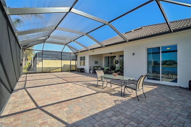 view of patio / terrace with ceiling fan and glass enclosure