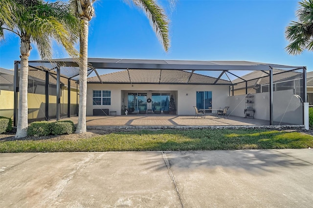 rear view of house featuring a lanai and a patio