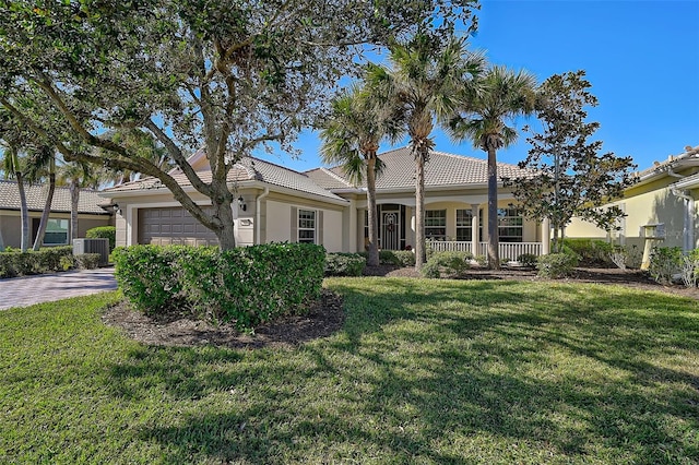 view of front of home with covered porch, a front lawn, a garage, and cooling unit