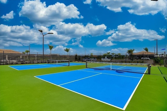 view of tennis court with basketball hoop