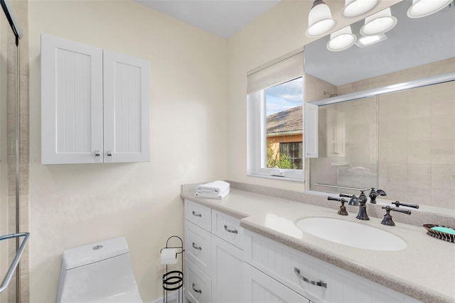 bathroom featuring vanity, toilet, and an enclosed shower