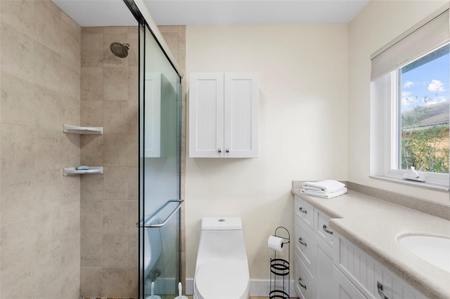 bathroom featuring a shower with door, vanity, and toilet