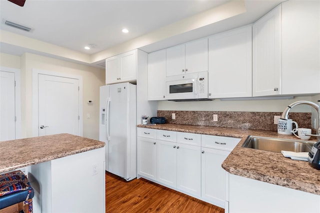 kitchen with white cabinetry, white appliances, and sink