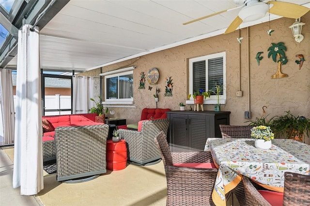 sunroom / solarium featuring ceiling fan