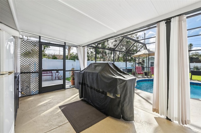 sunroom featuring a swimming pool