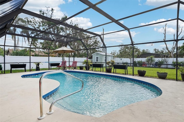 view of pool featuring glass enclosure, a yard, and a patio